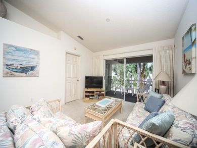Living Area with TV & Doors to Balcony